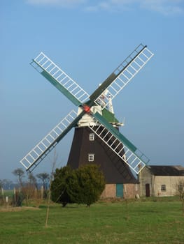 Windmill under bright blue sky