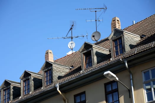 Antennas and satellite dishes on a residential building