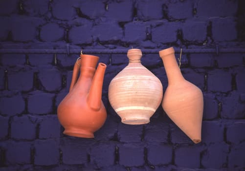 Clay pots and vases hang on a blue house wall in Jeddah,Saudi Arabia.