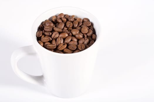 White cup with coffee beans