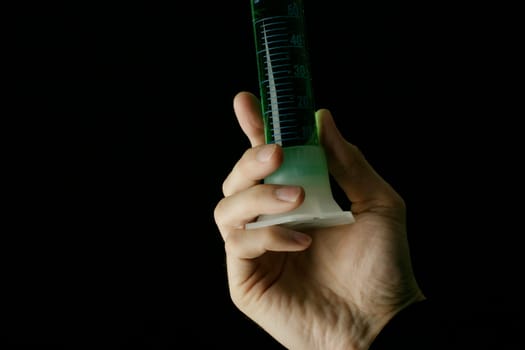 Measuring cylinder in hand