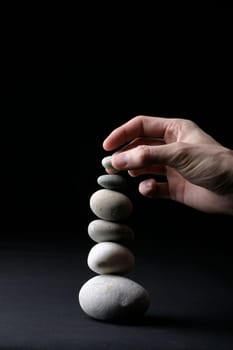 Stone pyramid and hand