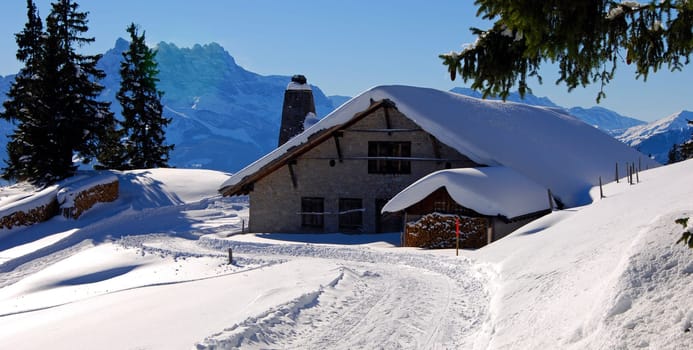 Alpine hut in front of the Dents du Midi,near Leysin,Switzerland