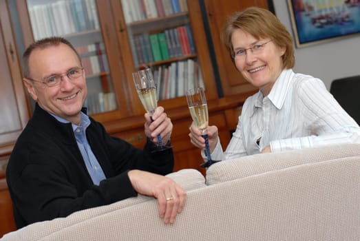 Middle-aged couple with champagne glasses