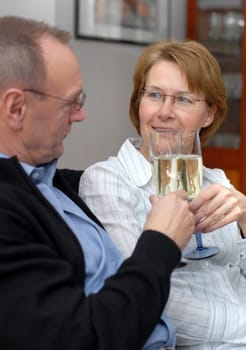 Middle-aged couple with champagne glasses