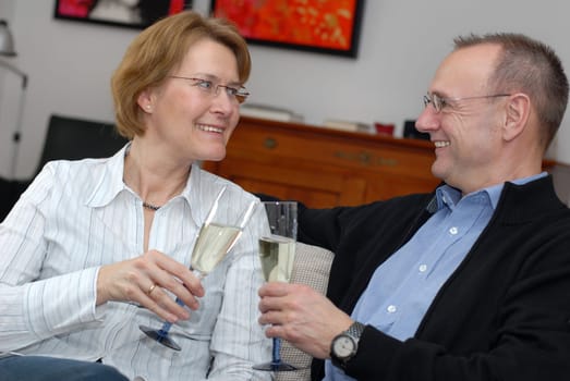 Middle-aged couple with champagne glasses