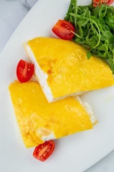 French tall omelette with arugula and cherry tomatoes