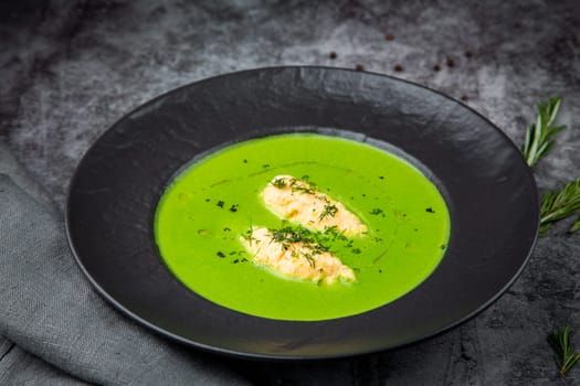 broccoli cream soup with pieces of chicken fillet