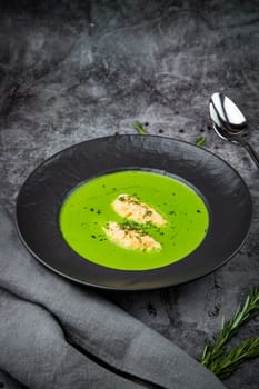 broccoli cream soup with pieces of chicken fillet