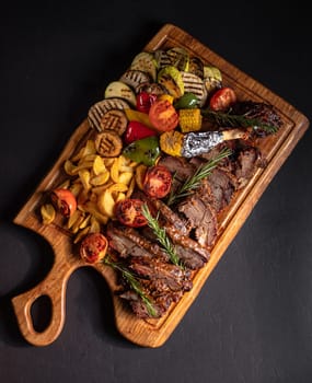 fried pieces of steak with vegetables on the grill