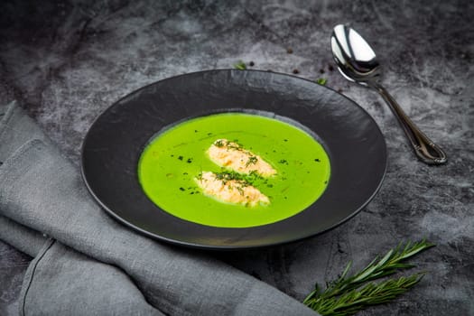 broccoli cream soup with pieces of chicken fillet