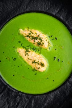 broccoli cream soup with pieces of chicken fillet