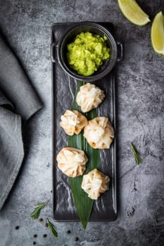 khinkali is a steamed Georgian dish of dough and ground beef. National cuisine, dark background. High quality photo