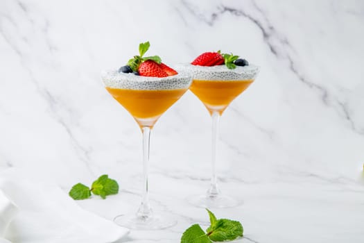 exotic fruit cocktails with berries and chia seed topping and mint