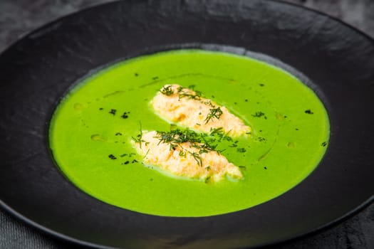 broccoli cream soup with pieces of chicken fillet