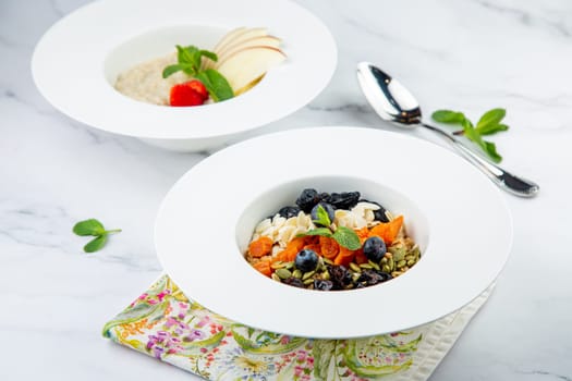 deep plate with cereals, berries, pistachios, dried apricots and raisins