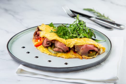 Breakfast of eggs with meat, herbs and drops of sauce