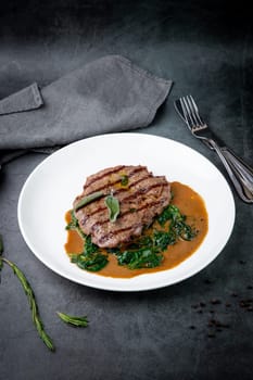 beef steak with gravy and herbs