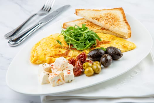 Breakfast of eggs with meat, herbs and drops of sauce