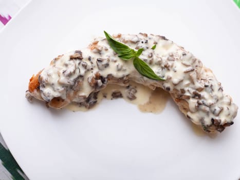 Salmon steak with creamy sauce and mushrooms with herbs. Asian style. High quality photo