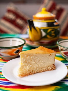 dessert cheesecake in oriental style with a teapot and a cup for tea. High quality photo