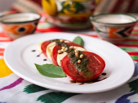 Italian caprese salad with tomatoes, mazzarella cheese and balsamic sauce. Asian style. High quality photo