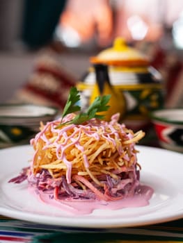 Capercaillie nest salad made of beets, pie potatoes, markovi and greens, topped with mayonnaise. Asian style. High quality photo