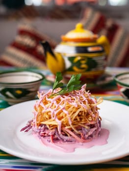Capercaillie nest salad made of beets, pie potatoes, markovi and greens, topped with mayonnaise. Asian style. High quality photo