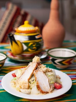 Caesar salad with chicken breast, herbs and cheese. Asian style. High quality photo