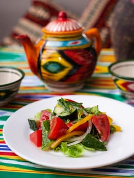 Vegetable salad of tomatoes, cucumbers, herbs and sweet pepper with butter. Asian style. High quality photo