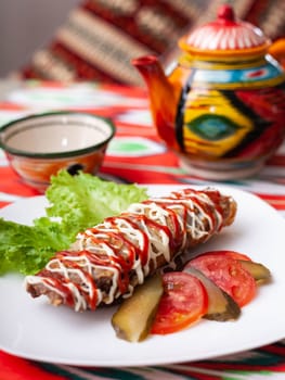 Brizol - a dish of omelet and beef covered with ketchup and mayonnaise in an oriental style. High quality photo