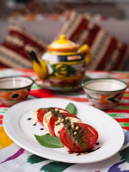 Italian caprese salad with tomatoes, mazzarella cheese and balsamic sauce. Asian style. High quality photo