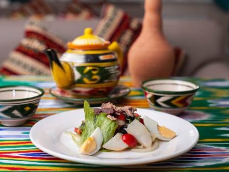 Salad with eggs, herbs, onions, cherry tomatoes, and tuna. Asian style. High quality photo