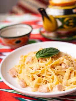 creamy pasta with chicken, basil and mushrooms, according to the Italian recipe. East style. High quality photo