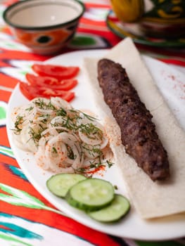 beef and lamb shashlik - grilled meat, minced meat. Served with vegetables, pickled onions, lavash bread and an oriental sauce. Eastern cuisine. High quality photo