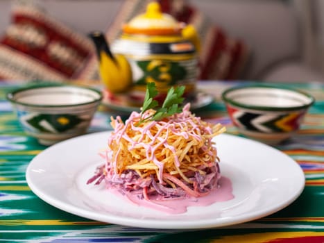 Capercaillie nest salad made of beets, pie potatoes, markovi and greens, topped with mayonnaise. Asian style. High quality photo