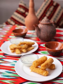 cheese sticks and chicken nuggets - fried cheese and breaded fried chicken served with a creamy sauce. Asian style. High quality photo