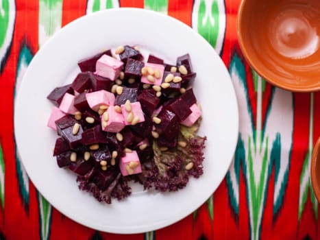 Beetroot and cheese salad with pine nuts dressed with butter. Asian style. High quality photo