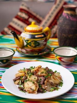 Fried potatoes with pieces of meat. Asian style. High quality photo