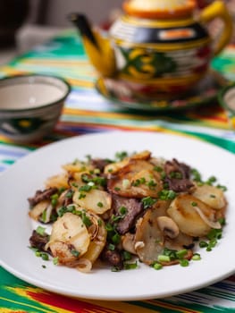 Fried potatoes with pieces of meat. Asian style. High quality photo