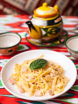 creamy pasta with chicken, basil and mushrooms, according to the Italian recipe. East style. High quality photo