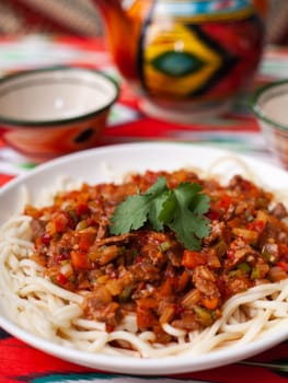 The oriental dish guiru lagman is homemade noodles fried with meat, vegetables and herbs. Eastern cuisine. High quality photo