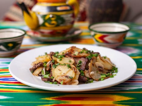 Fried potatoes with pieces of meat. Asian style. High quality photo