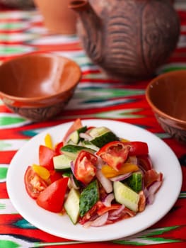 Tomato, cucumber, sweet pepper and onion salad, seasoned with oil. Asian style. High quality photo