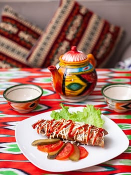 Brizol - a dish of omelet and beef covered with ketchup and mayonnaise in an oriental style. High quality photo