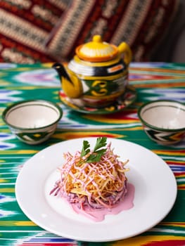 Capercaillie nest salad made of beets, pie potatoes, markovi and greens, topped with mayonnaise. Asian style. High quality photo