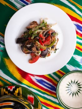 warm salad of green and red peppers, meat, eggplant, onions and tomatoes Asian style. High quality photo