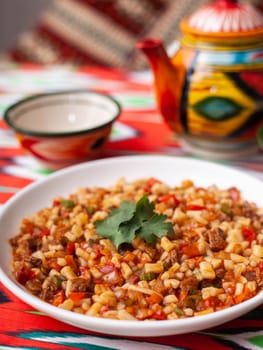 An oriental dish lagman - homemade noodles fried with meat and vegetables. Eastern cuisine. High quality photo