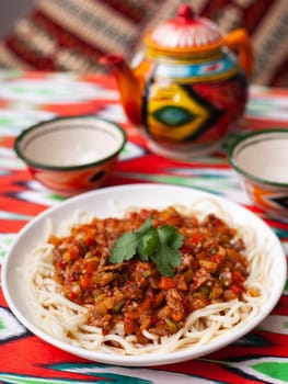 The oriental dish guiru lagman is homemade noodles fried with meat, vegetables and herbs. Eastern cuisine. High quality photo