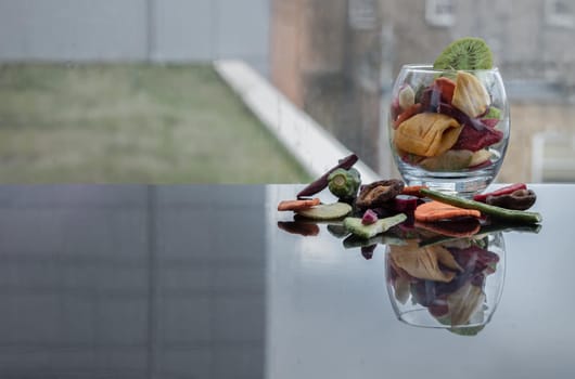 Different colorful dried fruits and vegetables in the glass. Crispy mixed veggies and fruits, Healthy snacks food, Copy space, Selective focus.